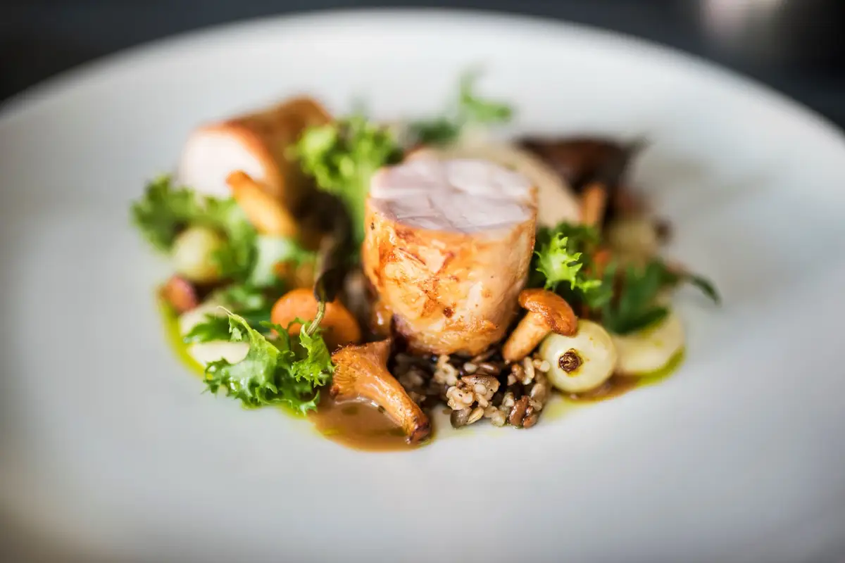 Plated main course with wild rice and chanterelles